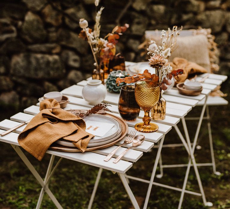 Rustic table setting with brass knives and forks