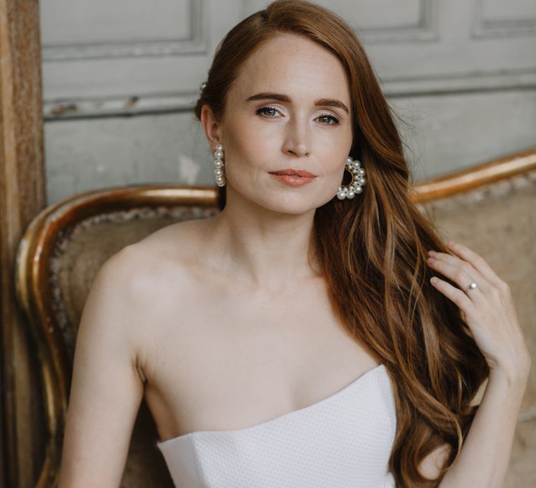 White red headed bride with long hair swept to the side in a strapless wedding dress | Rebecca Goddard Photography