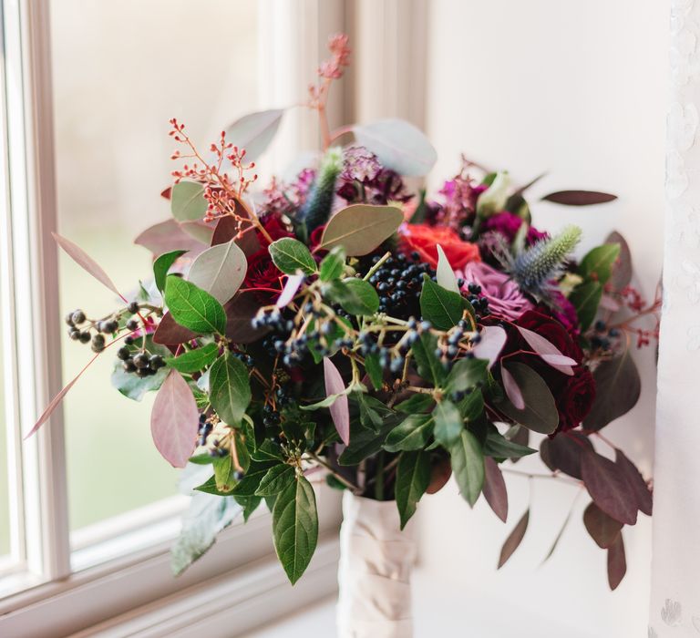 Pink floral bouquet with brightly coloured flowers 