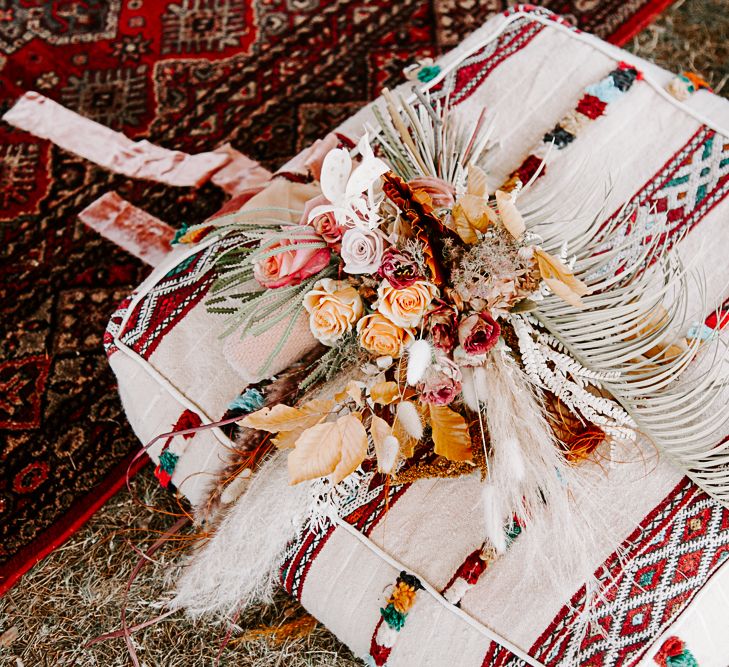 Dried floral bouquet on Moroccan inspired cushion