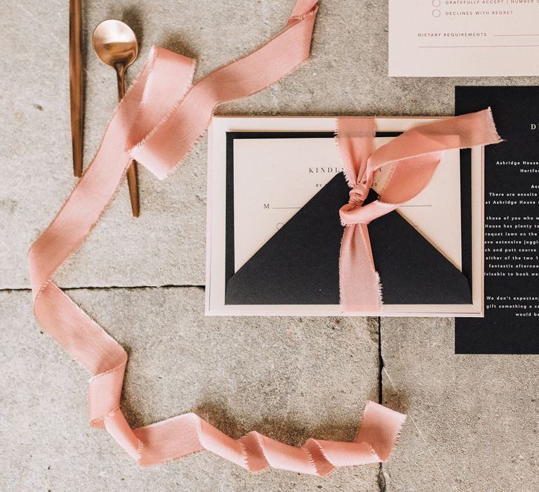 Black and white wedding stationery suite tied up with dusky pink ribbon 