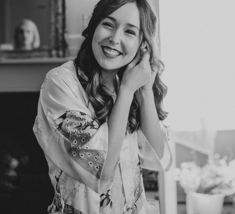 Black & white image of bride getting ready on the morning of her wedding day 