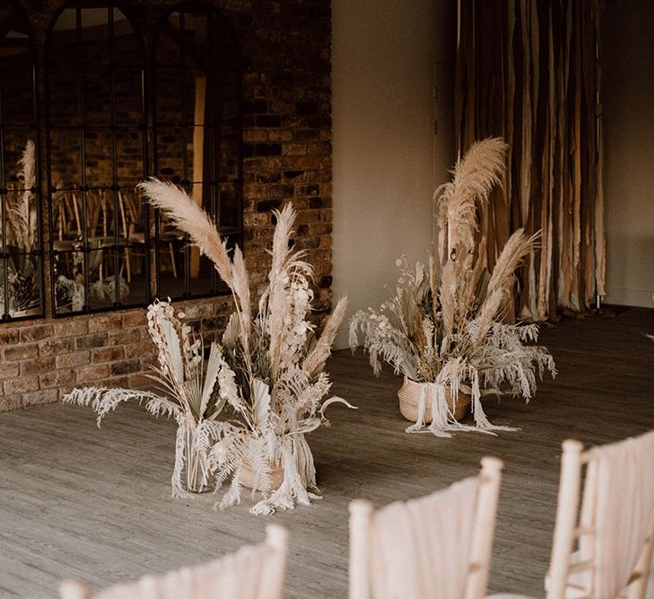 Wedding ceremony altar dried wedding flower arrangements in baskets 