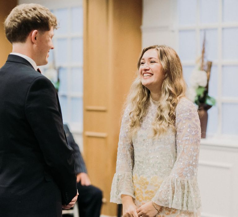 Bride and groom smiling at wedding registry office wedding