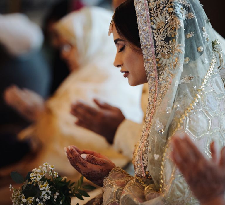 Bengali bride praying at her intimate Islamic wedding reception at The Ivy, Birmingham 