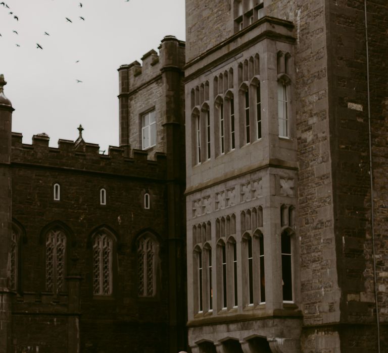 Bride & groom stand outside of Markree Castle in Ireland on their wedding day