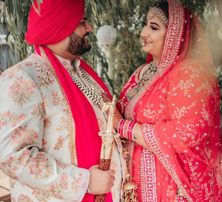 Bride & groom look lovingly at one another as they pose for post-wedding couples portraits