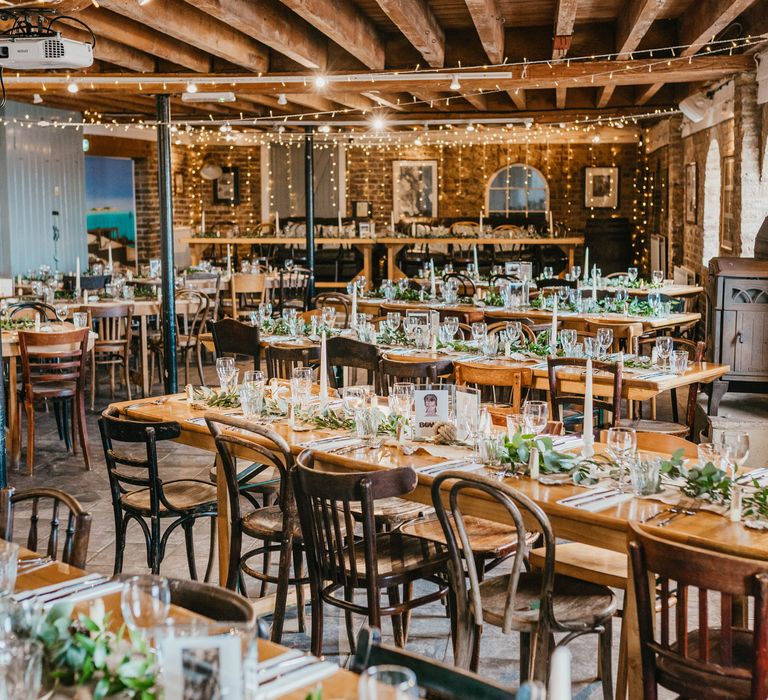 East Quay Venue complete with rustic vibe, wooden tables and fairy lights above tables