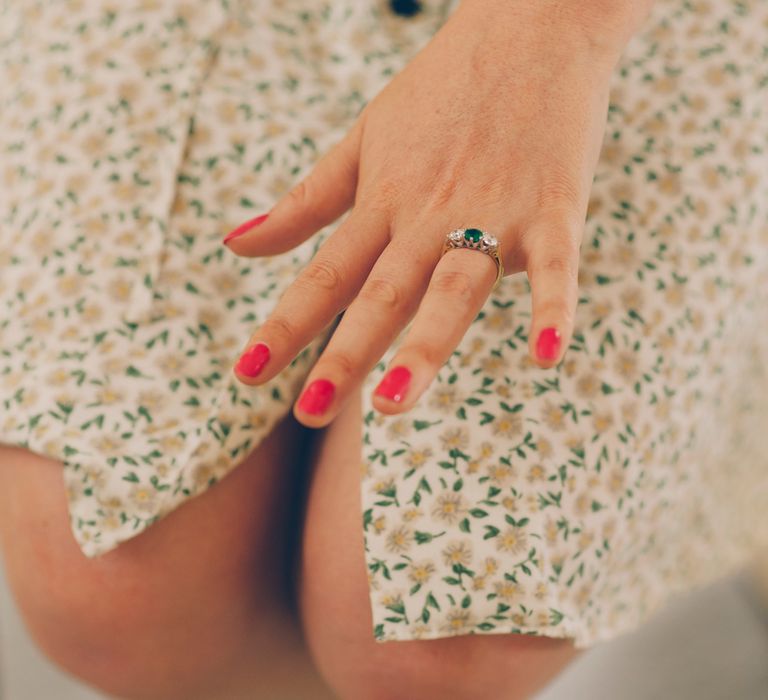 Bride shows off her engagement ring with green stone and two diamonds either side | Charlotte Knee Photography