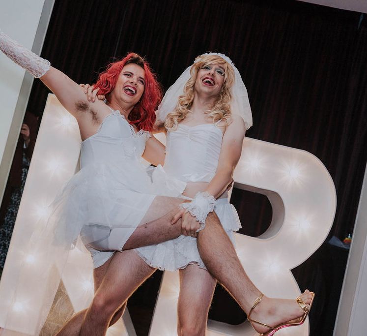 Grooms celebrate on their wedding day during drag reception dance | Kim Williams Weddings