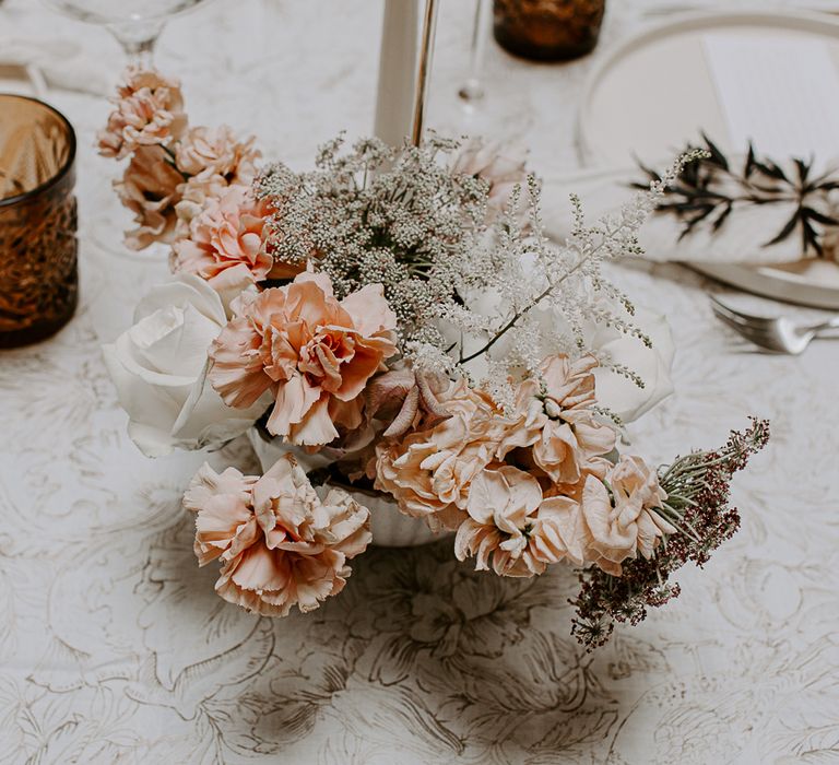 Delicate white and peach wedding flower arrangements for minimal wedding 