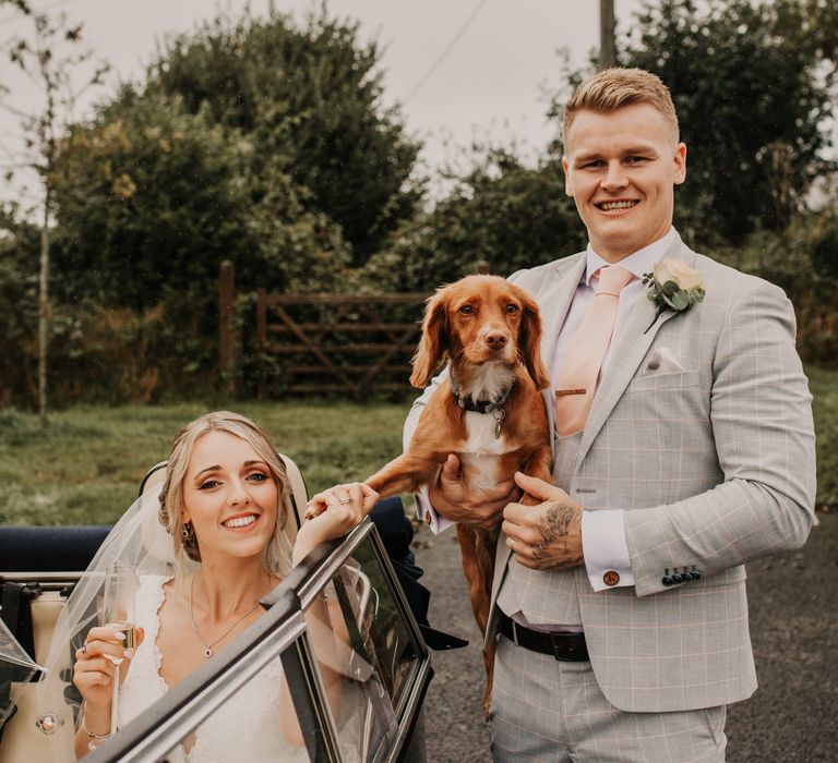 Bride and groom with their pet dog at their wedding