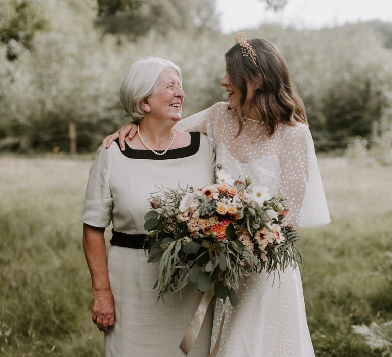 Bride stands with her mother on her wedding day