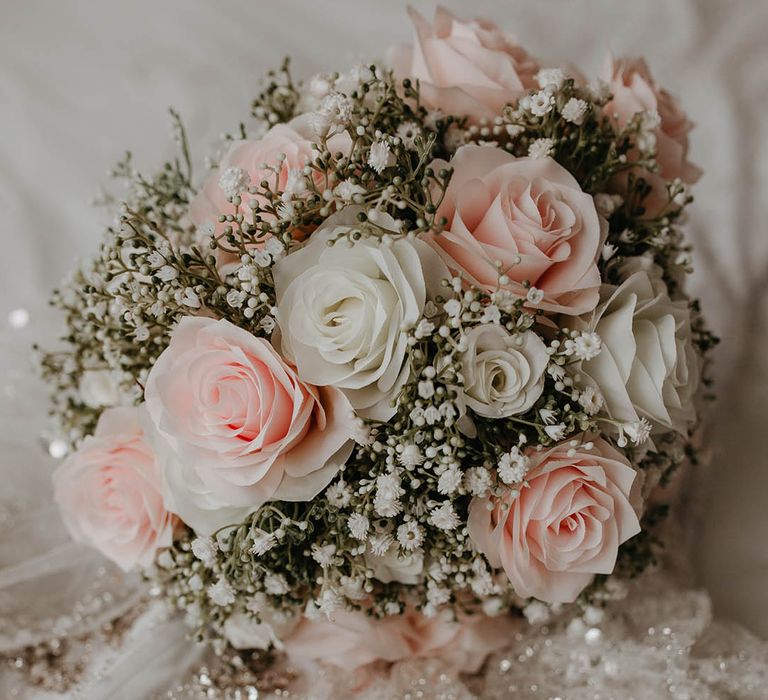 Classic white & pink floral bouquet complete with roses and green foliage