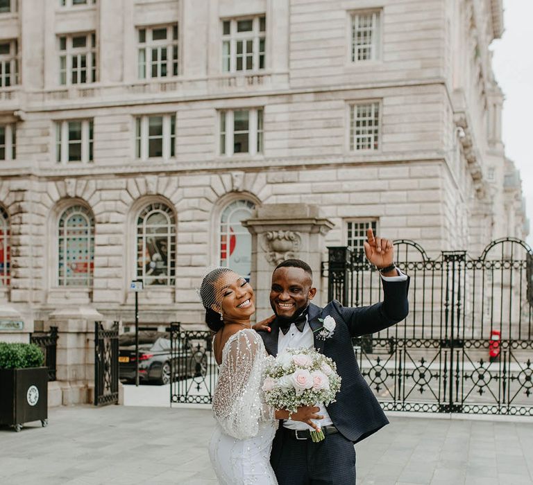 Bride & groom celebrate as they walk through Liverpool with one another