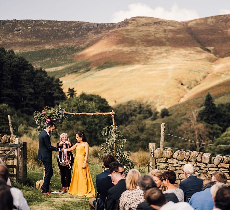 Bride & groom during wedding ceremony outdoors