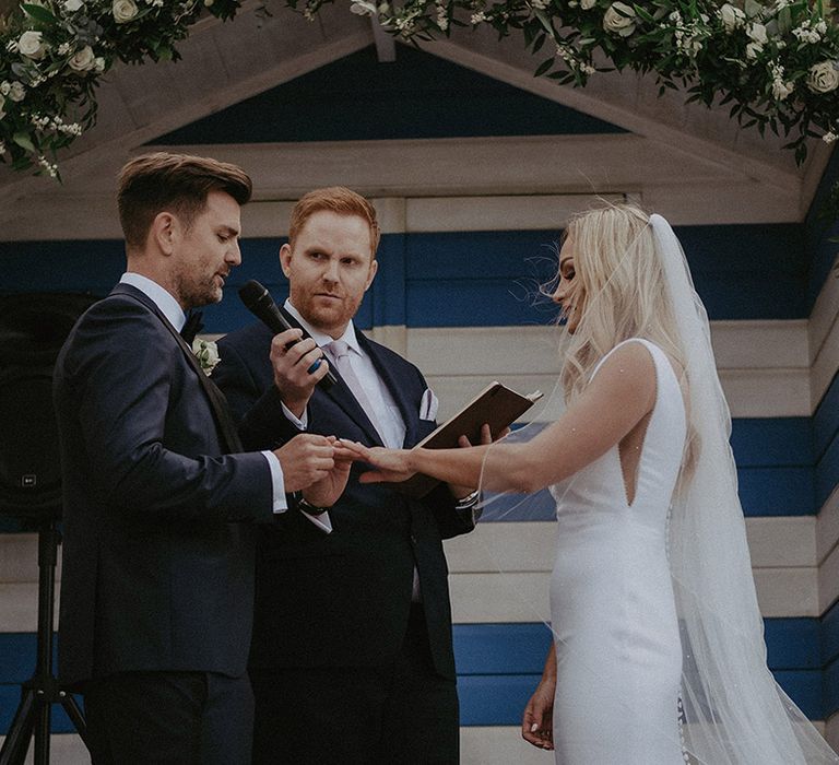 Bride and groom at beach hut wedding ceremony