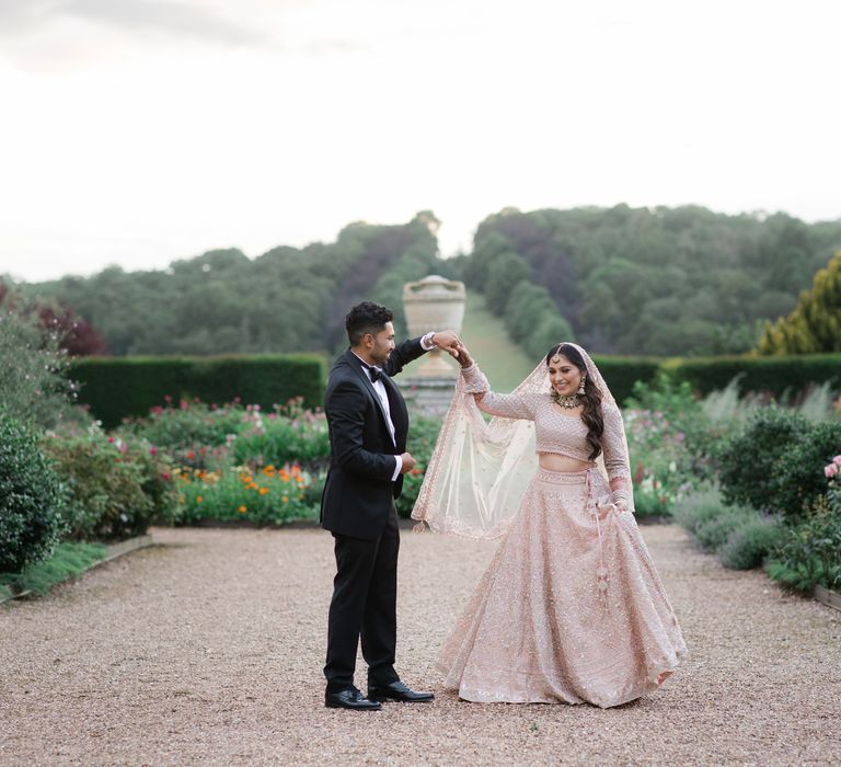 Bride & groom walk through the grounds of Ragley Hall