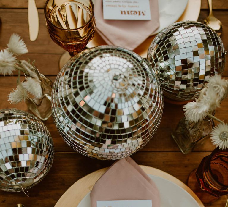 Retro boho tablescape complete with disco balls