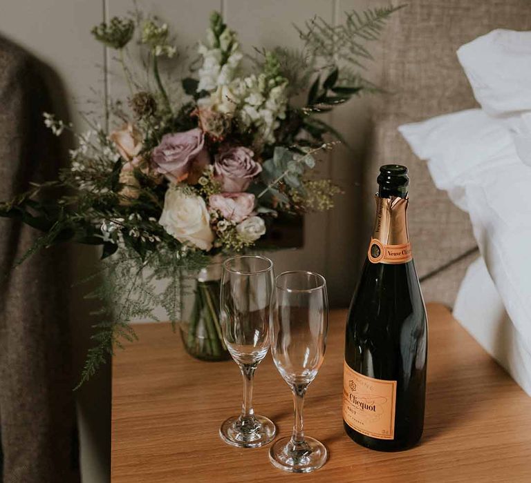 Champagne and two glasses with floral bouquet 