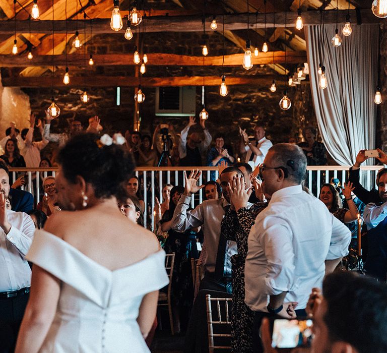 Wedding guests clap and celebrate the wedding of Camilla and Russell 