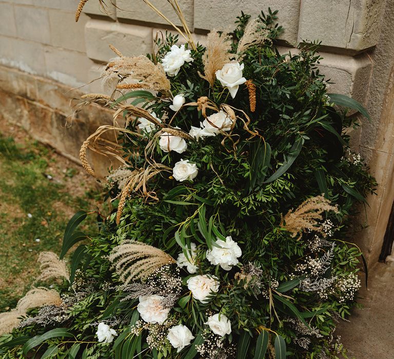 White rose, greenery and dried flower display for clean and natural styled wedding