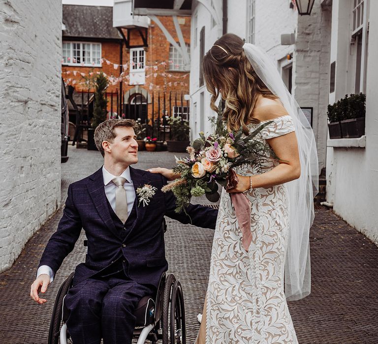 Bride and groom reach for each other ready for their hotel wedding 