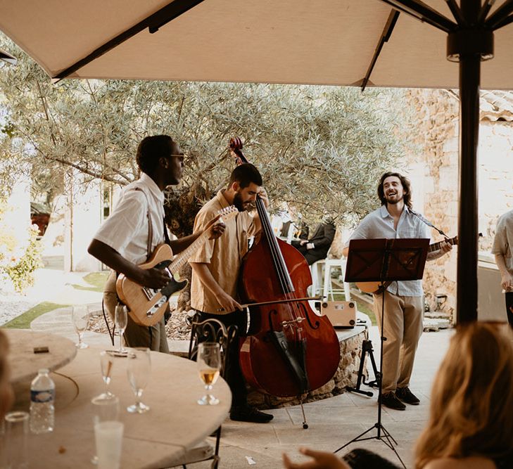 Band plays outdoors during wedding reception in Mas Loisonville France for classic wedding