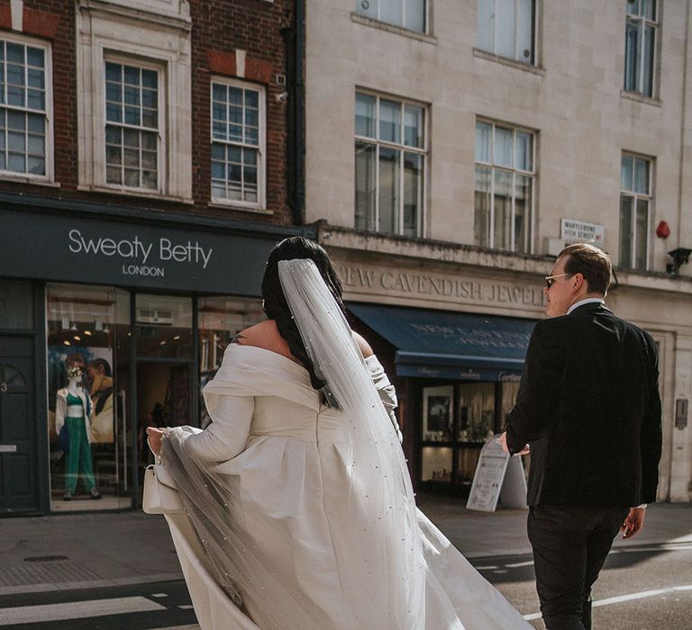 Bride walks across the road in London on the morning of her wedding day