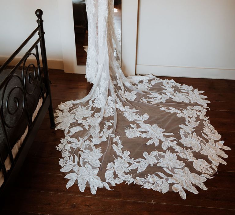 Lace Essense Of Australia wedding dress hanging in front of mirror on the morning of wedding day