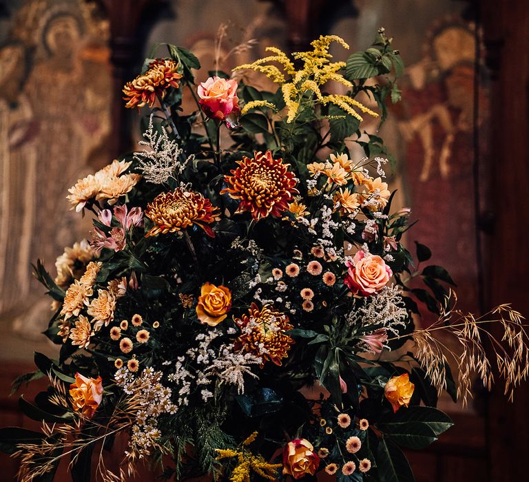 Orange, pink and yellow wedding flowers with green leaves and foliage 