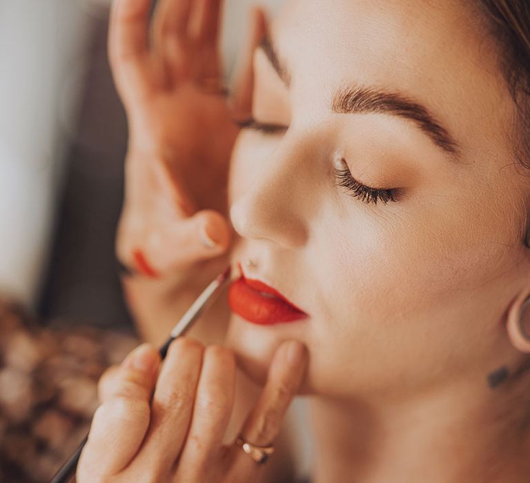 Bride wears bright red lipstick on her wedding day