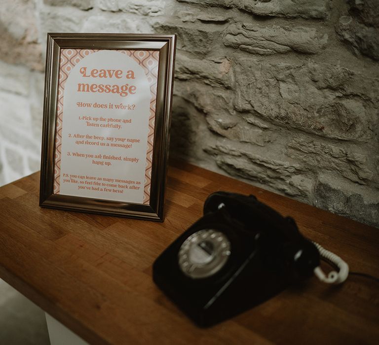 Old school vintage black telephone wedding audio guestbook and instructions in 70's inspired font and orange colour in frame 