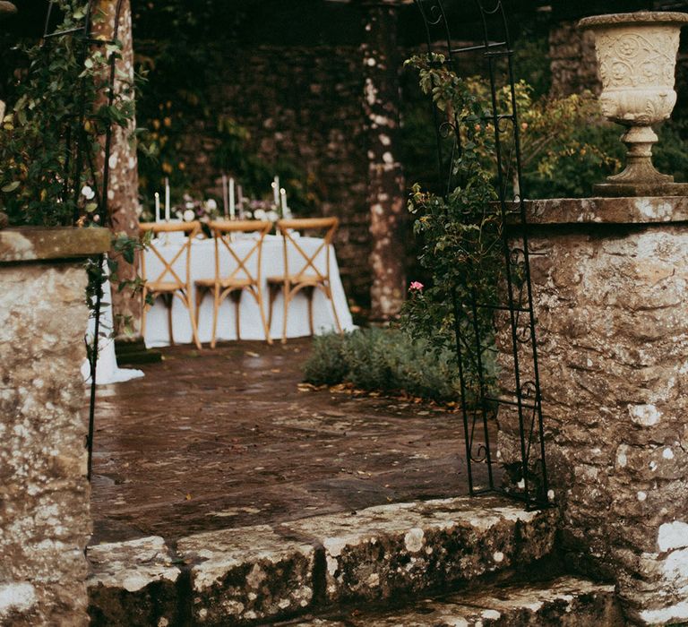 Black delicate arch at Holesfoot wedding going through to outdoor minimal wedding tablescape 