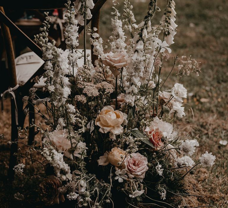 Neutral flower arrangement with natural wildflowers for outdoor wedding ceremony 