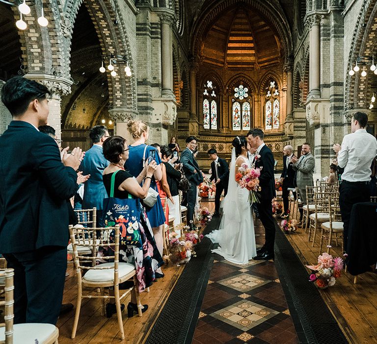 Bride & groom kiss after wedding ceremony at St Stephen's Hampstead church