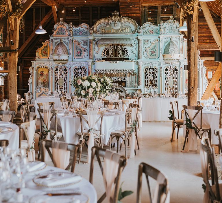 Pink and blue vintage organ decoration at Preston Court rustic wedding venue with the tables in a pastel pink and green theme 