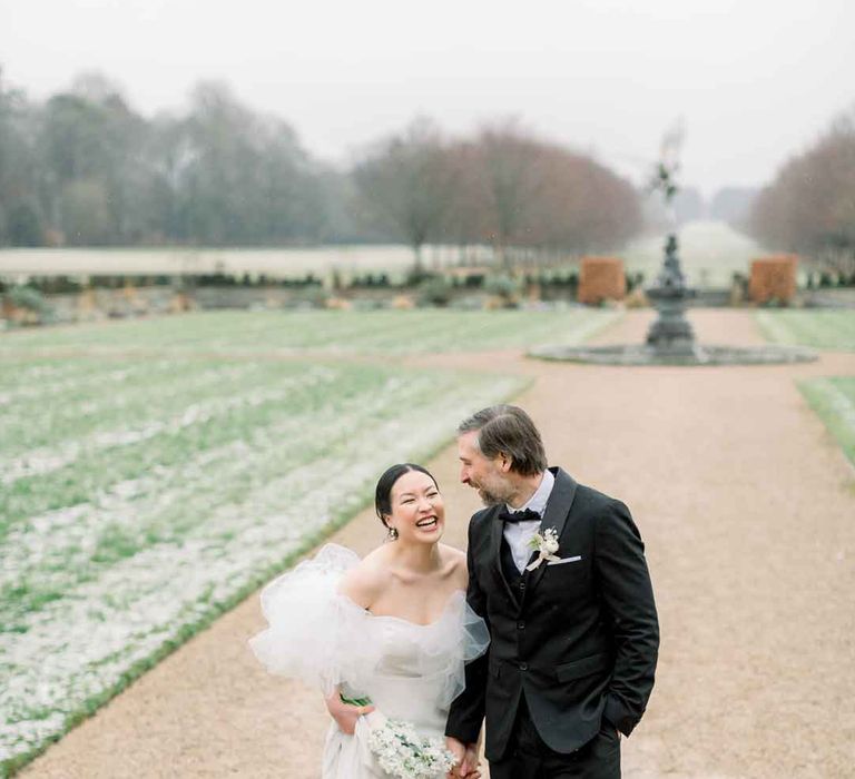 Bride and groom walking the grounds of UK country house wedding venue 