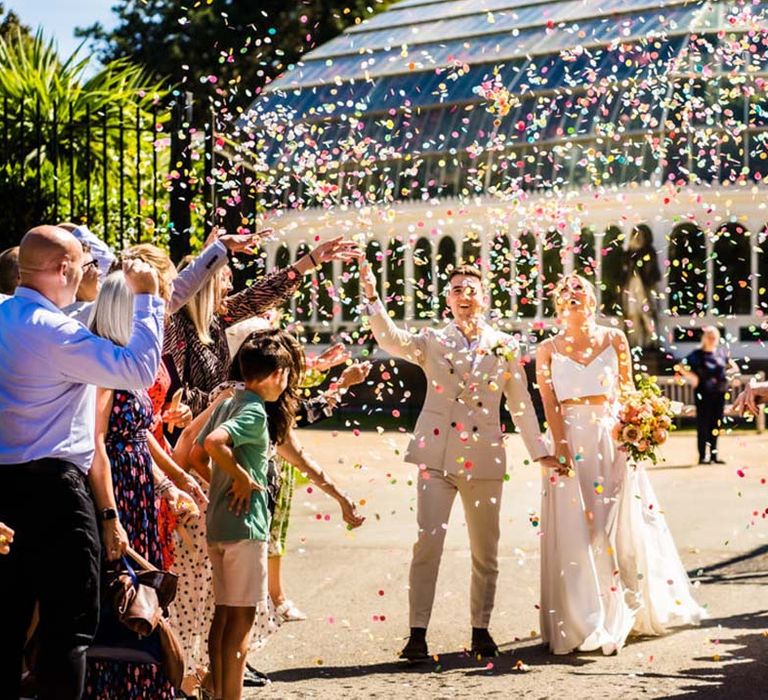 Colourful confetti from Flutter, Darlings! for the bride and groom after their ceremony in the glasshouse wedding venue in Liverpool 