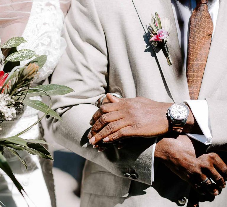 Father of the bride in light grey suit walking down the aisle arm in arm with bride at Tunnels Beaches coastal wedding 