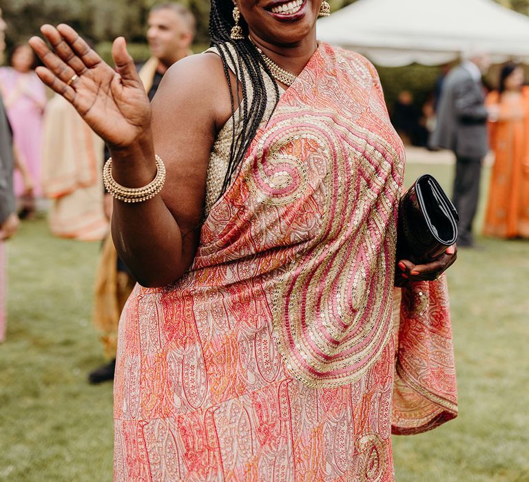 Wedding guest enjoying themselves at the fun and colourful wedding celebrations 