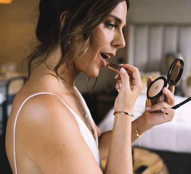 Bride puts on lipstick from Charlotte Tilbury 