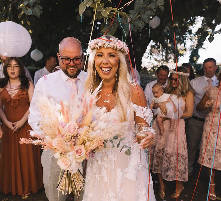 Colourful streamers erupt for the bride and groom in celebration 