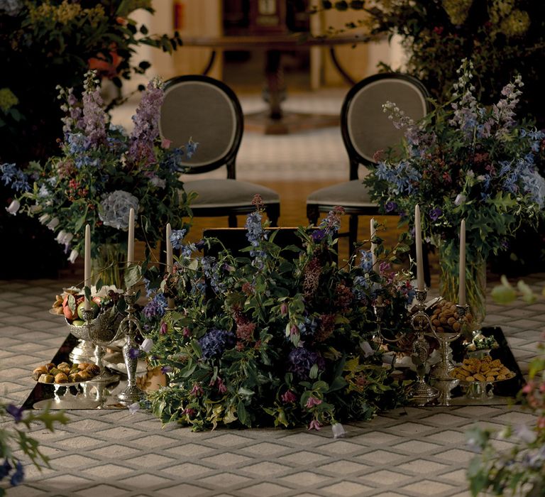 Purple wedding flower arrangement decorating the altar space at Signet Library for wedding 