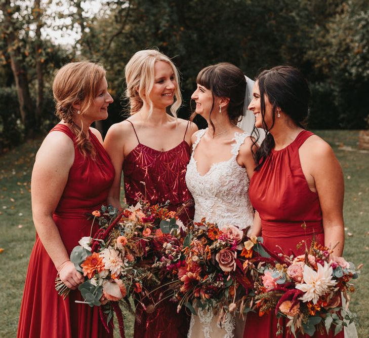 Bridal party portrait with bridesmaids in rust dresses at Millbridge Court wedding