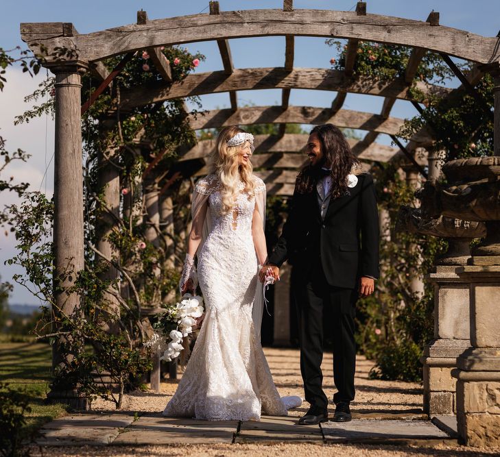 Bride and groom walking through the gardens at Euridge Manor 