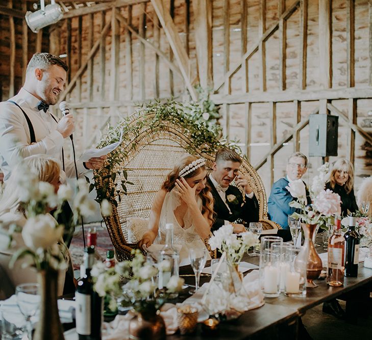 Best man delivering his wedding speech at the barn reception 