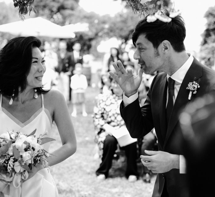 Bride and groom laughing during the outdoor wedding reception 