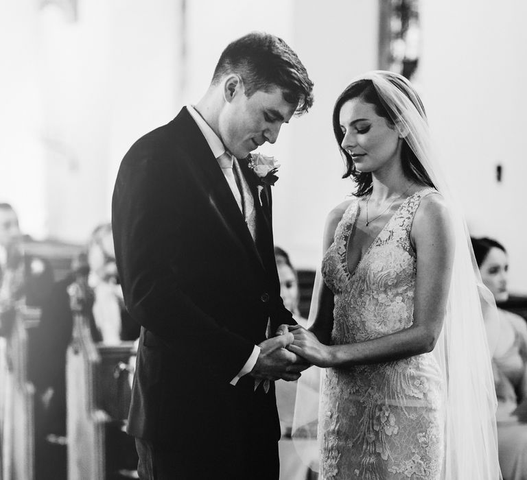 Bride & groom exchanging rings during wedding ceremony