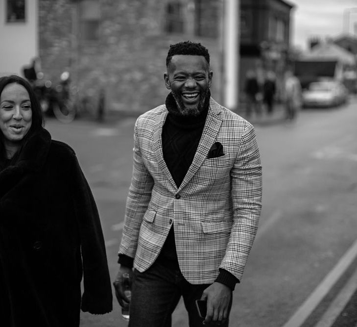 Stylish wedding guest in check blazer